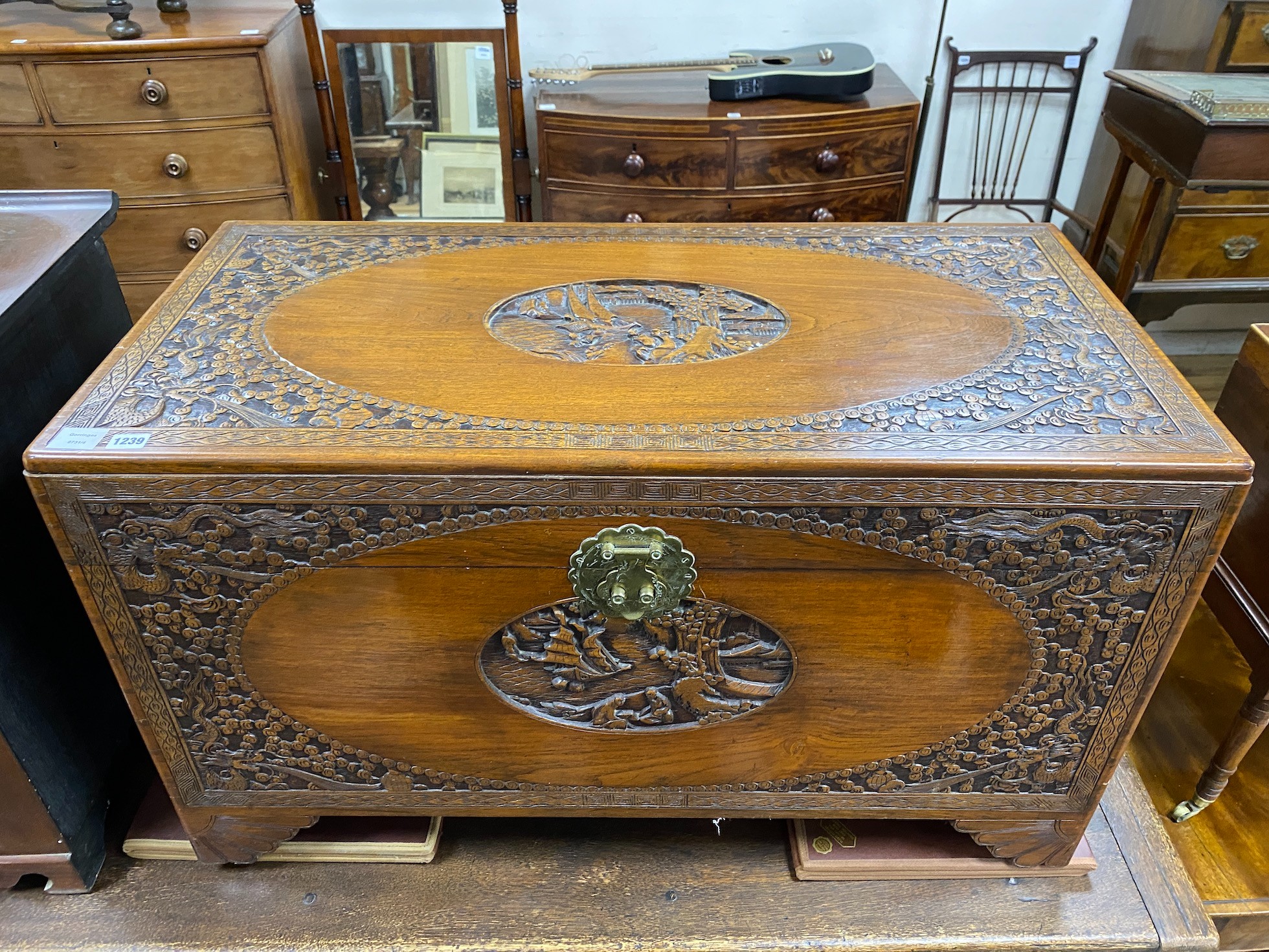 A carved Chinese camphor wood coffer, length 104cm, depth 52cm, height 63cm